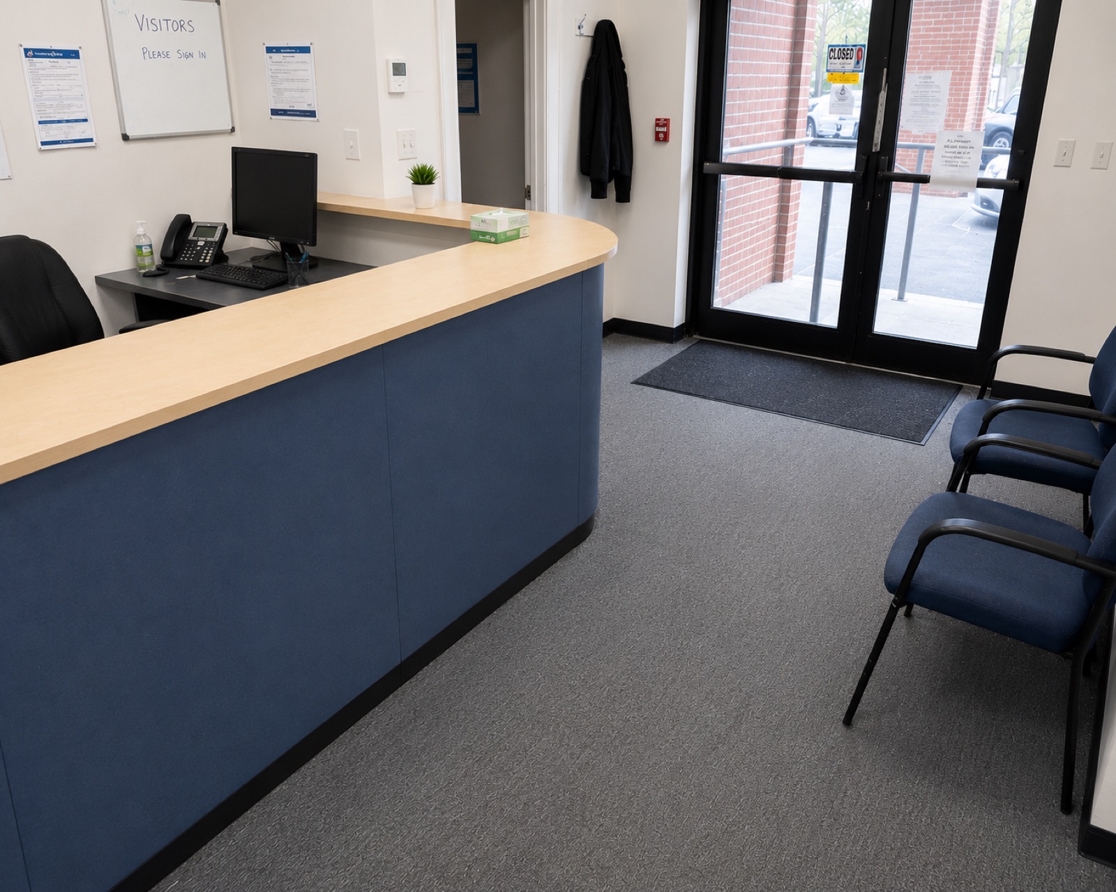 The same reception after cleaning, with the counter wiped down, floor cleaned and matting replaced